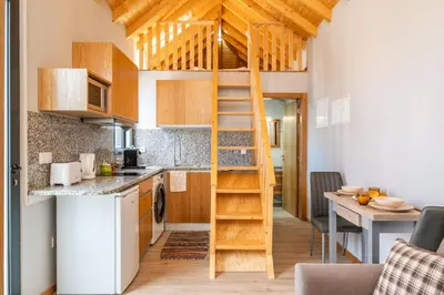 a small kitchen with a ladder in a tiny apartment at Salsa Country House I I I in Porto Moniz