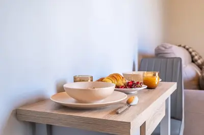 a wooden table with a bowl of food on it at Salsa Country House I I I in Porto Moniz