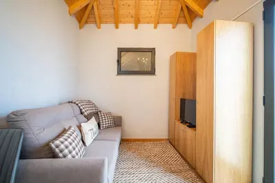a living room with a couch and a tv at Salsa Country House I I I in Porto Moniz