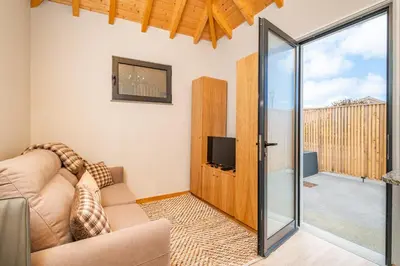 a living room with a couch and a sliding glass door at Salsa Country House I I I in Porto Moniz