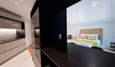 a hotel room with a bed and a television at Daysy Loft by LovelyStay in Funchal