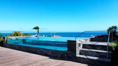 a swimming pool with the ocean in the background at Daysy Loft by LovelyStay in Funchal