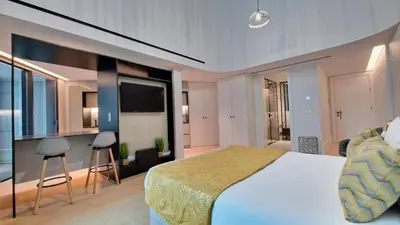 a bedroom with a large bed and a television at Daysy Loft by LovelyStay in Funchal