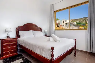 a bedroom with a bed and a large window at Pico The Best View in Ribeira Brava