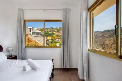 a bedroom with a bed and a large window at Pico The Best View in Ribeira Brava