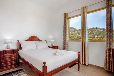 a bedroom with a bed and a large window at Pico The Best View in Ribeira Brava