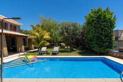 a villa with a swimming pool and a yard at Vila Esperança by An Island Apart in Calheta
