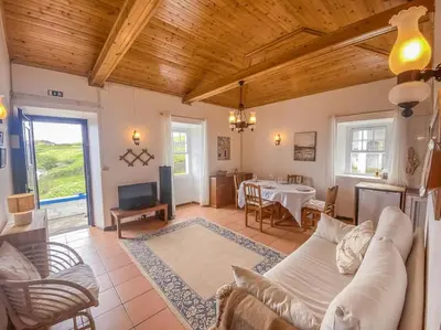 a living room with a couch and a table at Sun Island Retreat - Great Sunny Island Sea view in Vila do Porto