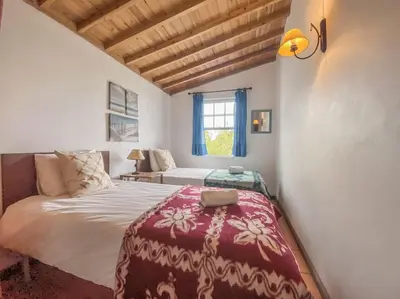 a bedroom with a large bed and a window at Sun Island Retreat - Great Sunny Island Sea view in Vila do Porto