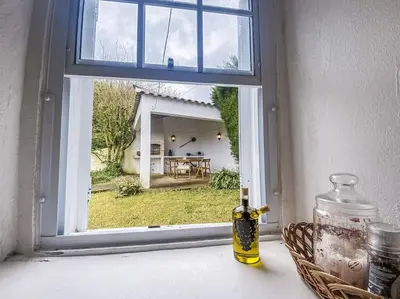 a bottle of oil sitting on a window sill at Sun Island Retreat - Great Sunny Island Sea view in Vila do Porto
