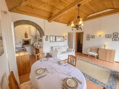 a living room with a table and a kitchen at Sun Island Retreat - Great Sunny Island Sea view in Vila do Porto
