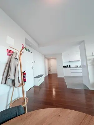 a living room with wooden floors and white walls at Seaview wonder apartment by Anna in Funchal