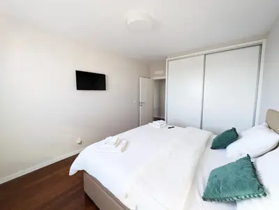 a bedroom with two beds and a tv at Seaview wonder apartment by Anna in Funchal