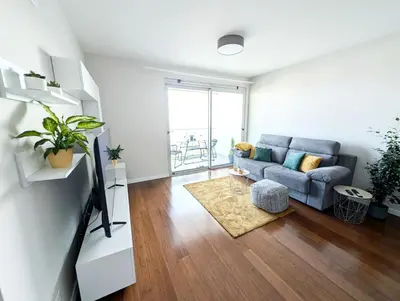 a living room with a couch and a tv at Seaview wonder apartment by Anna in Funchal