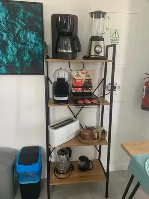 a shelf with various appliances on it in a kitchen at Quinta da Oliveira in Ponta do Sol