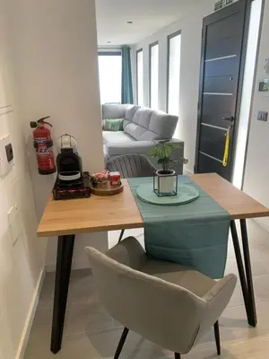 a living room with a table and a couch at Quinta da Oliveira in Ponta do Sol