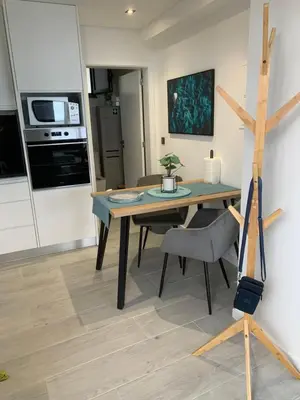 a kitchen and dining room with a table and chair at Quinta da Oliveira in Ponta do Sol