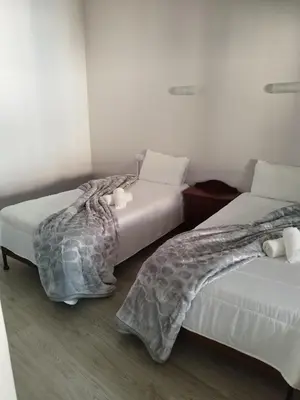two beds sitting next to each other in a room at Alojamento Central II in Funchal