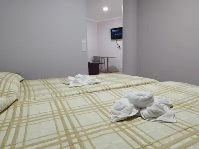 two beds with towels on them in a room at Alojamento Central II in Funchal