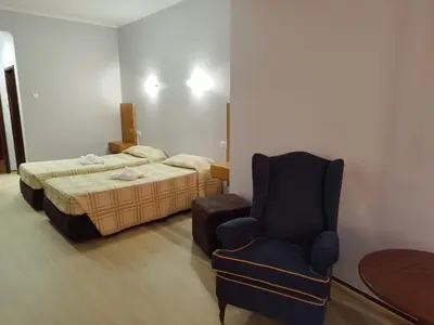 a bedroom with a bed and a chair in it at Alojamento Central II in Funchal