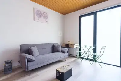 a living room with a couch and a large window at GuestReady - A lovely refuge in Madeira in Machico
