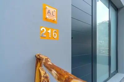 a sign on the side of a building with the number at GuestReady - A lovely refuge in Madeira in Machico