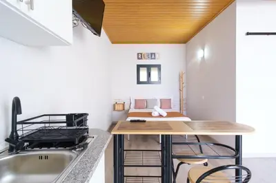 a kitchen with a sink and a bed in a room at GuestReady - A lovely refuge in Madeira in Machico