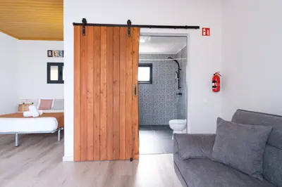 a living room with a sliding door and a bedroom at GuestReady - A lovely refuge in Madeira in Machico