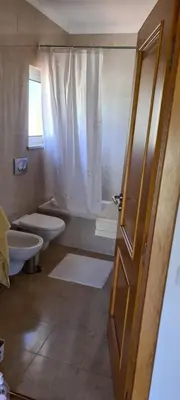 a bathroom with two toilets and a shower at Casa Riomara in Lagos