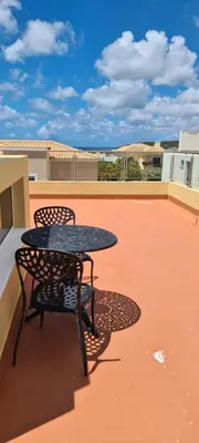 a patio table and chairs on a roof at Casa Riomara in Lagos