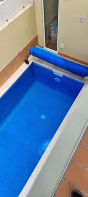 a swimming pool with blue water in a room at Casa Riomara in Lagos