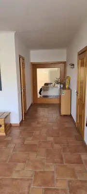 a room with a bedroom with a bed and a tile floor at Casa Riomara in Lagos