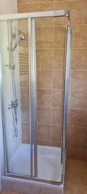 a shower with a glass door in a bathroom at Casa Riomara in Lagos