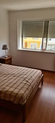 a bedroom with a bed and a large window at Casa Riomara in Lagos