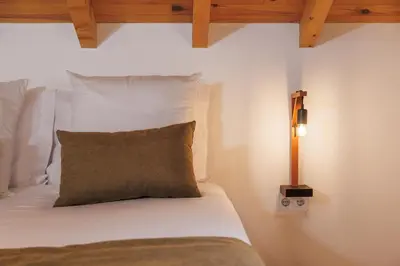 a bedroom with a bed with a pillow and a lamp at Mountain Chalet by Lavibes in São Vicente