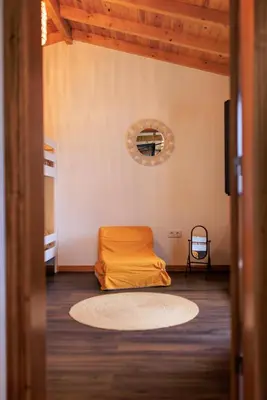 a room with a bed in the corner of a room at Mountain Chalet by Lavibes in São Vicente