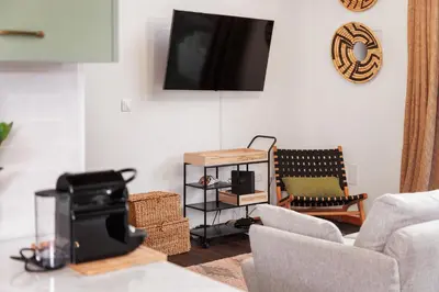 a living room with a couch and a tv at Mountain Chalet by Lavibes in São Vicente