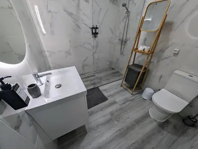 a bathroom with a sink and a shower and a toilet at Apartamento da Praia in Sagres