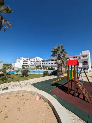 a playground with a slide next to a pool at Apartamento da Praia in Sagres