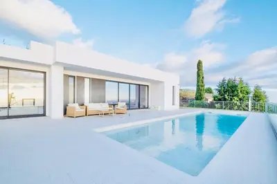 a villa with a swimming pool and a house at Vila Cales e Chadas by Your Madeira Rentals in Arco da Calheta