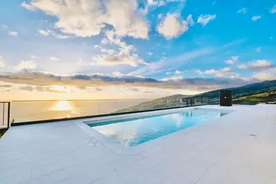 a swimming pool on the roof of a building at Vila Cales e Chadas by Your Madeira Rentals in Arco da Calheta
