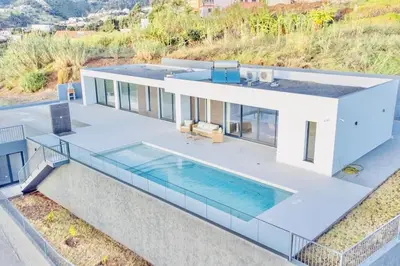 an aerial view of a house with a swimming pool at Vila Cales e Chadas by Your Madeira Rentals in Arco da Calheta