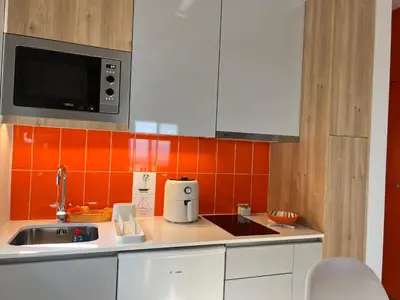 a room with a white desk and a tv on a wall at Caniçal houses - Madeira in Caniçal