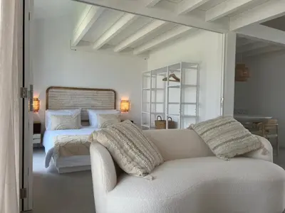 a living room with a couch and a bed at Casa Ingrina in Carrapateira