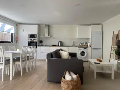a kitchen and living room with a couch and a table at Brooklyn&Fennel House in Funchal