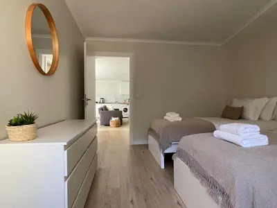 a bedroom with two beds and a mirror at Brooklyn&Fennel House in Funchal