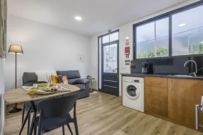 a kitchen and living room with a table and a sink at Colinas by Homie in São Vicente