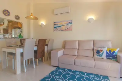 a living room with a couch and a table at Vila Luz Mar in Luz