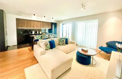 a kitchen with a island with blue bar stools at LUX OCEAN VIEW Apartment Varino 05 in Funchal