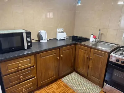 a kitchen with a microwave and a sink at Casa Rosa in Ribeira Brava